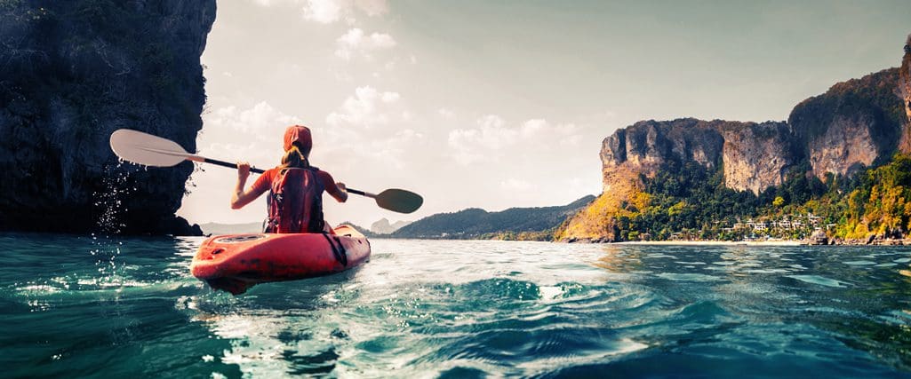 sole person in a kayak on a river